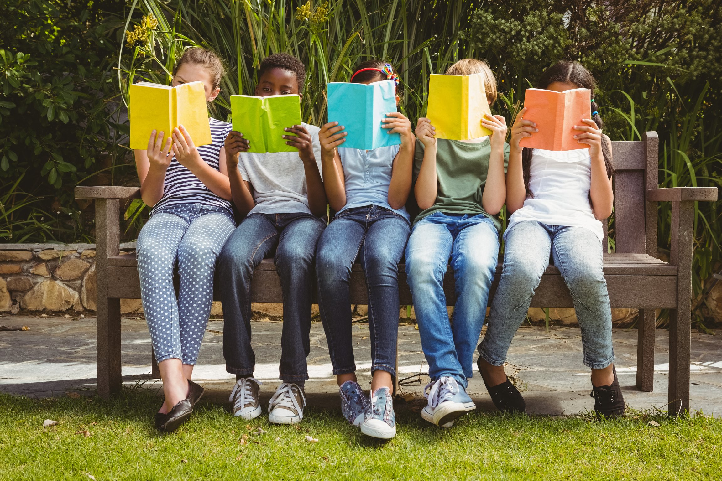 Children reading books at park