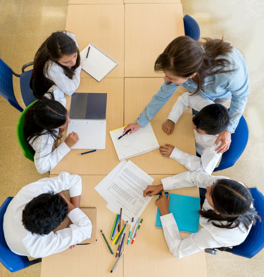 Teacher teaching students at the school